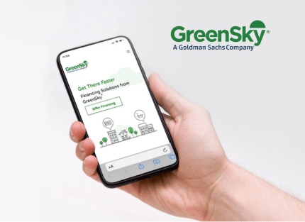 Person holding a smartphone displaying the GreenSky website. The screen shows options for financing solutions, and the GreenSky logo is at the top. GreenSky logo is also on the right.